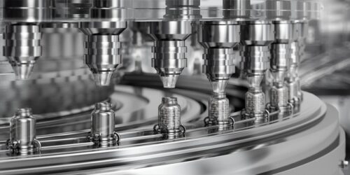 Automated tablet filling machine with glass bottles on a production conveyor line. CDMO digital marketing relies on specialized expertise and knowledge in a crowded market.