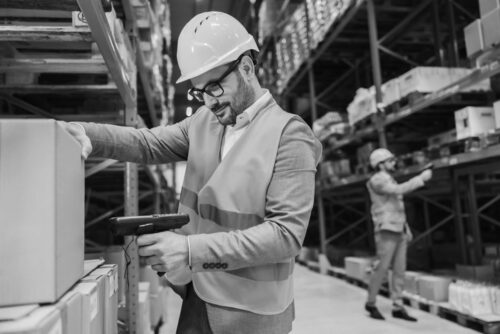 An inspector scanning box with goods in storage. Lead generation for packaging companies