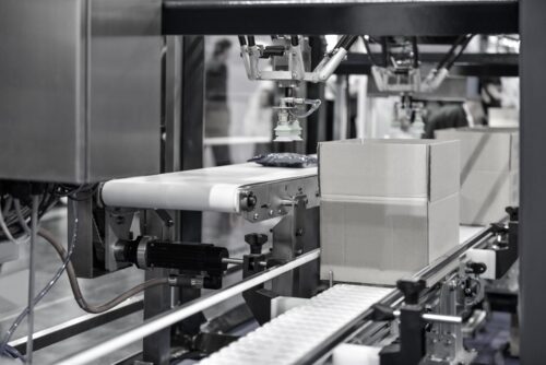 Cardboard boxes on conveyor belt. A packaging marketing strategy is necessary in today's competitive marketplace.